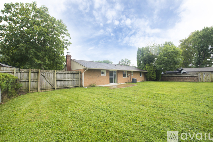 A house with a fenced backyard.