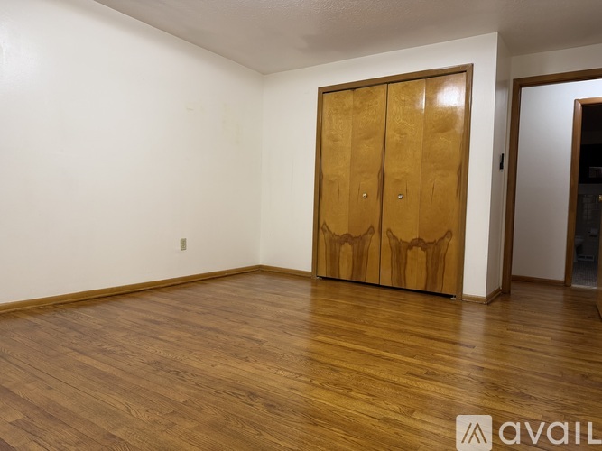 A room with wooden floors and a wooden door.
