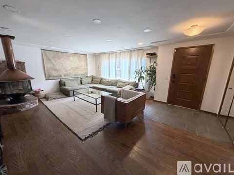 A living room with a sofa set and a fireplace.