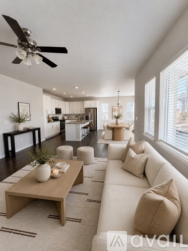 A living room with a white couch and a wooden coffee table.