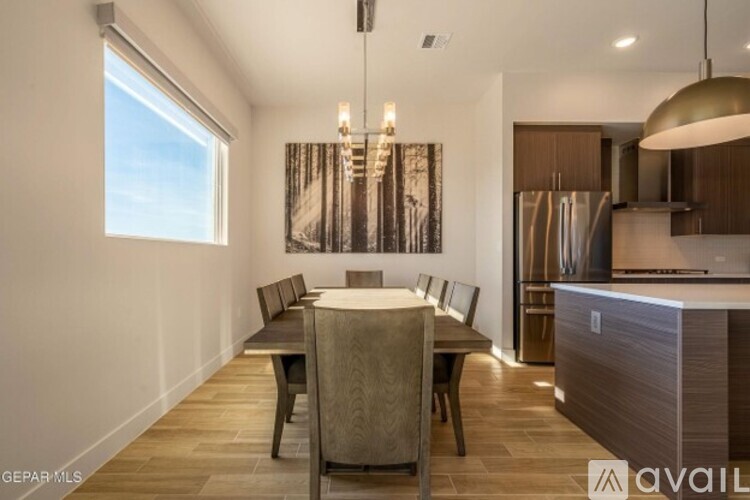A modern dining room with a large table and chairs.