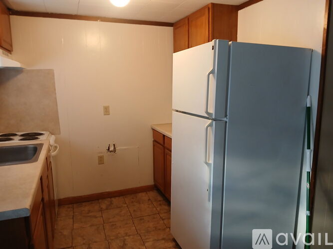 A kitchen with a white fridge and a white stove top.