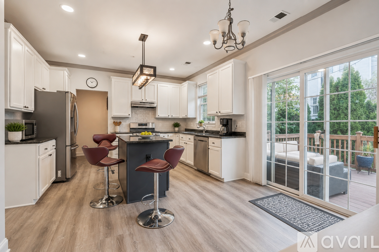 A modern kitchen with white cabinets and a large island.