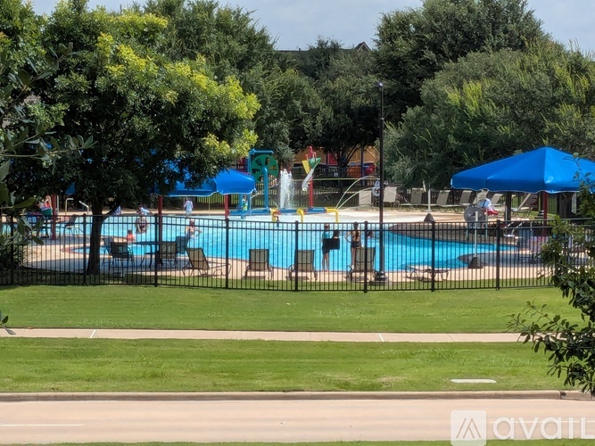 A pool with a slide and people in it.
