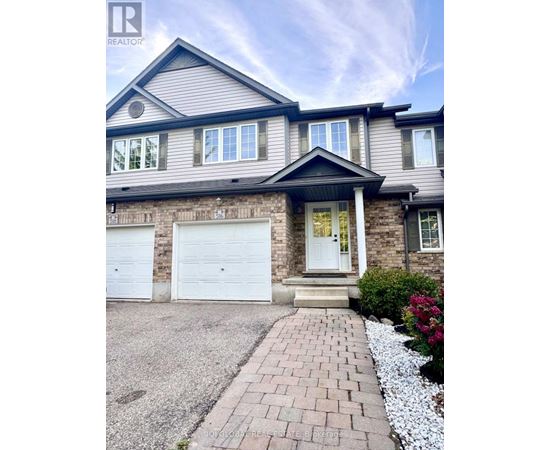 A house with a grey roof and white garage doors.