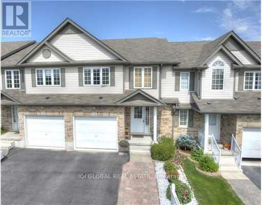 A large, two-story house with a garage is for sale.