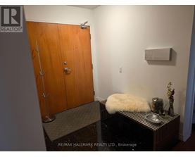 A brown door with a silver handle and a sign that says REALTOR.