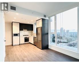 A modern kitchen with a view of the city.