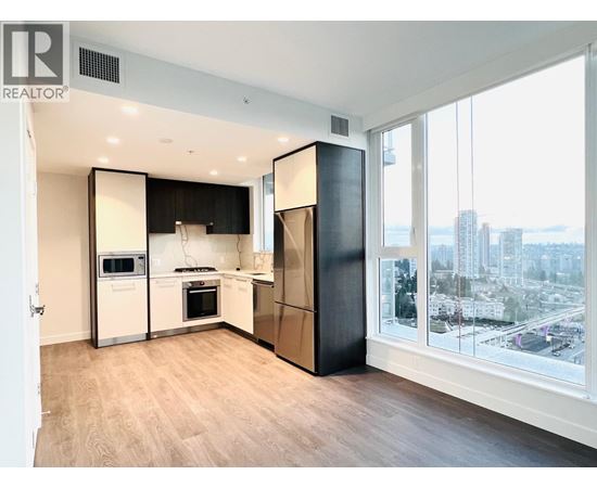 A modern kitchen with a view of the city.