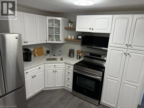 A kitchen with white cabinets and stainless steel appliances.