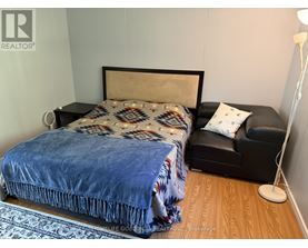 A bedroom with a bed and a couch.
