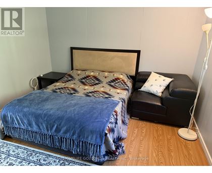 A bedroom with a bed and a couch.