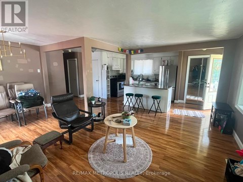 A living room with a black chair and a wooden coffee table.