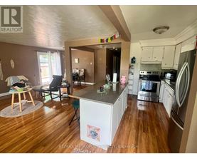 A kitchen with a refrigerator, oven, and dishwasher.