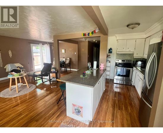 A kitchen with a refrigerator, oven, and dishwasher.