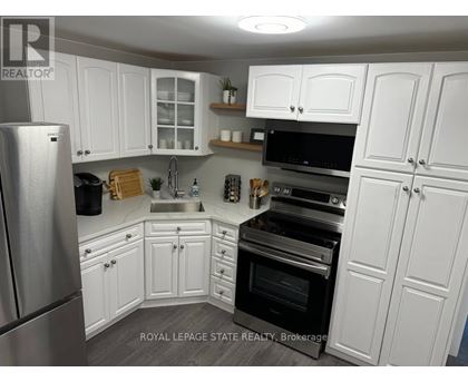 A kitchen with white cabinets and stainless steel appliances.