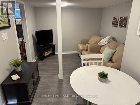A living room with a white couch and a television.