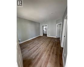 A room with wooden floors and white walls.