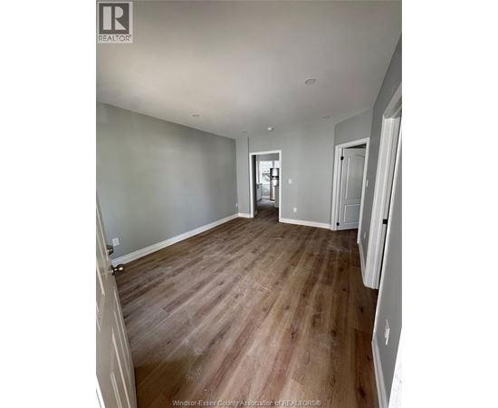 A room with wooden floors and white walls.