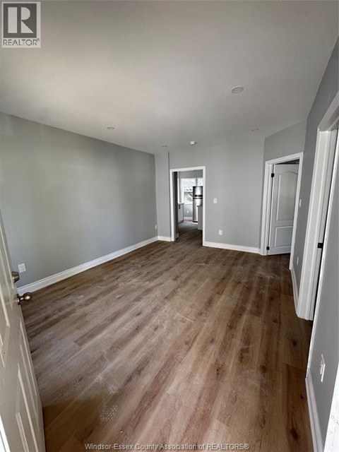 A room with wooden floors and white walls.