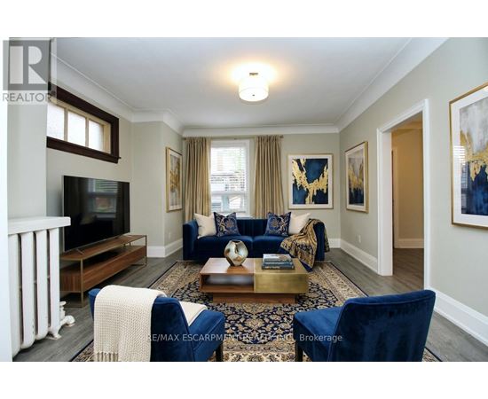 A living room with a blue couch and a television.