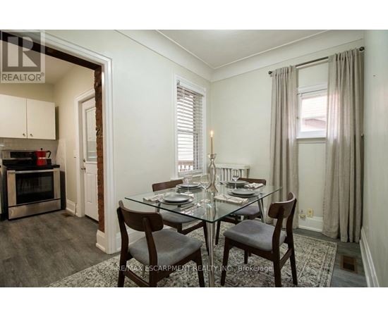 A dining room with a glass table and chairs.