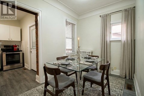 A dining room with a glass table and chairs.
