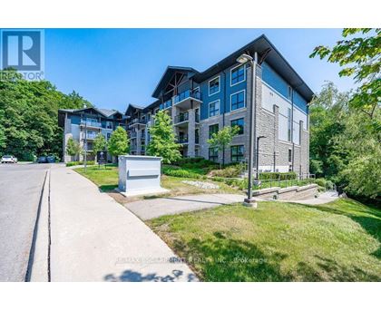 A modern apartment building with a parking area in front.