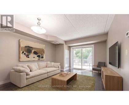 A living room with a couch, coffee table, and television.