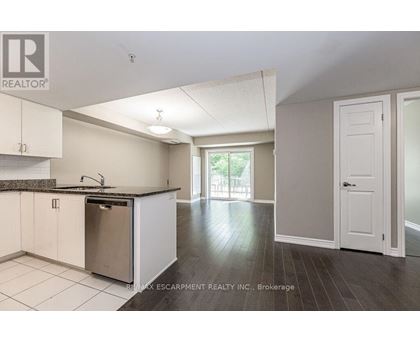 A kitchen with white cabinets and a black granite countertop.