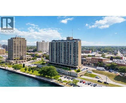 A cityscape with a body of water in the foreground and a Realtor logo in the corner.