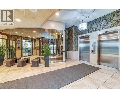 A lobby with a Realtor sign on the wall.