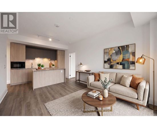 A living room with a couch, coffee table, and a painting on the wall.