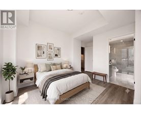 A bedroom with a large bed and a plant.
