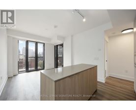 A spacious room with a large window and sliding glass doors.
