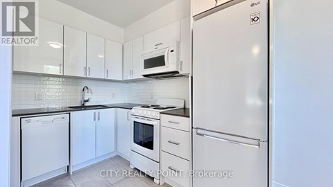 A kitchen with white appliances and cabinets.
