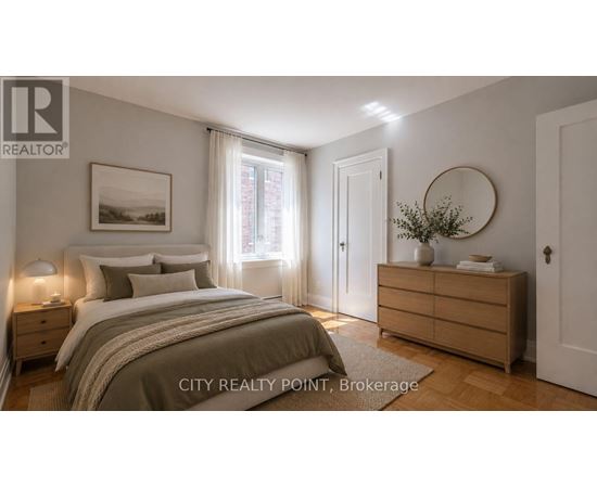 A well-lit bedroom with a large bed, a nightstand, and a dresser.
