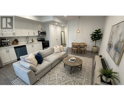 A living room with a grey couch and a coffee table.