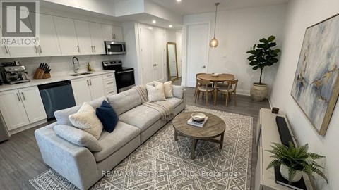 A living room with a grey couch and a coffee table.