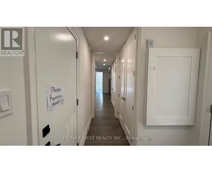 A hallway with a sign that says "Please Remove Stools".
