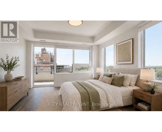 A bedroom with a large bed and a view of the city.
