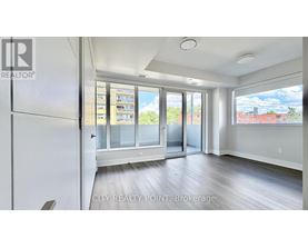 A spacious room with a view of the city through large windows.
