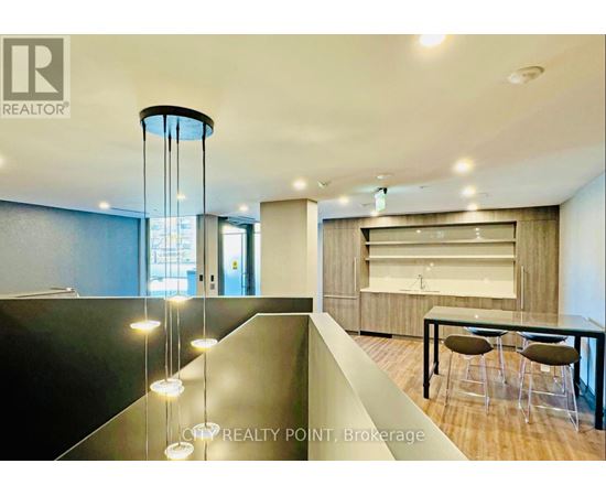 A modern dining area with a glass table and chairs.