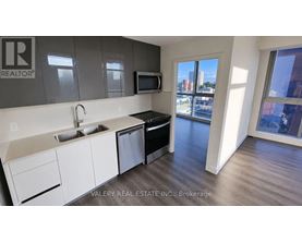 A kitchen with a sink, stove, and microwave.