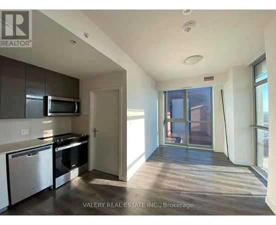 A kitchen with white cabinets and a black stove top oven.