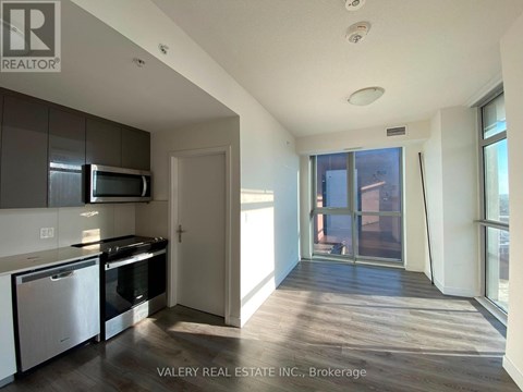 A kitchen with white cabinets and a black stove top oven.