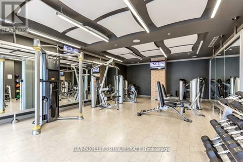A gym with a variety of equipment including treadmills, weights, and exercise machines.