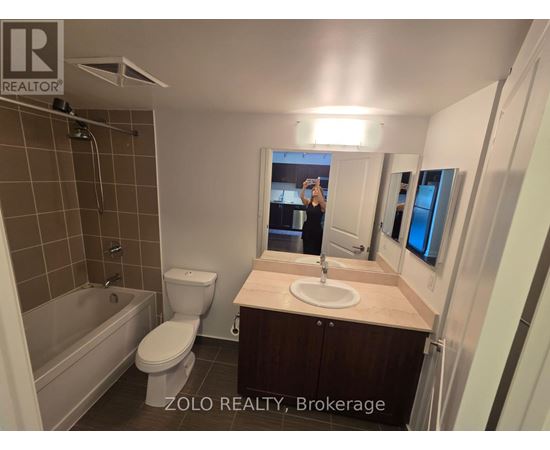 A bathroom with a toilet, sink, and bathtub.