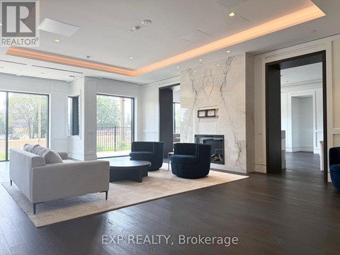 A living room with a white couch and a fireplace.