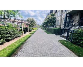 A long brick pathway leads through a residential area.